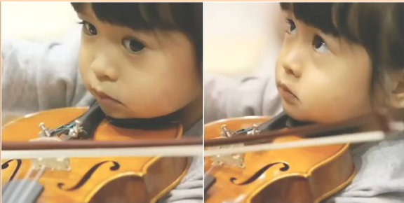 幼少期のHIMARIさんがバイオリンを弾く写真